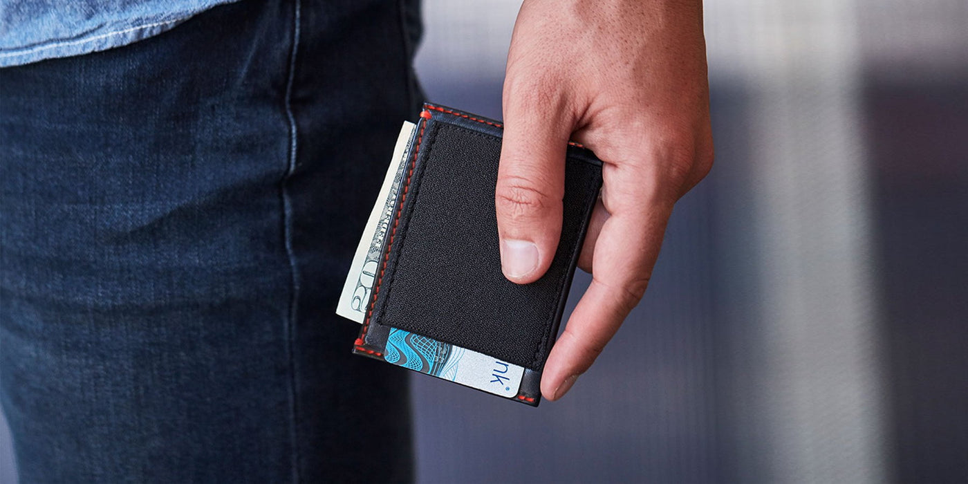 Man holding SLIMJIMMY wallet